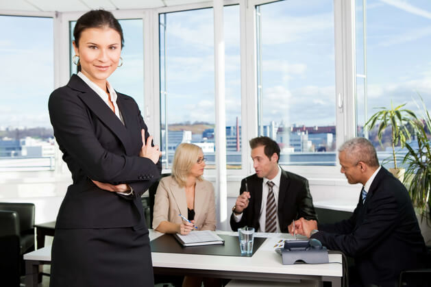 tax-compliance woman standing in front of her business team discussing tax compliance